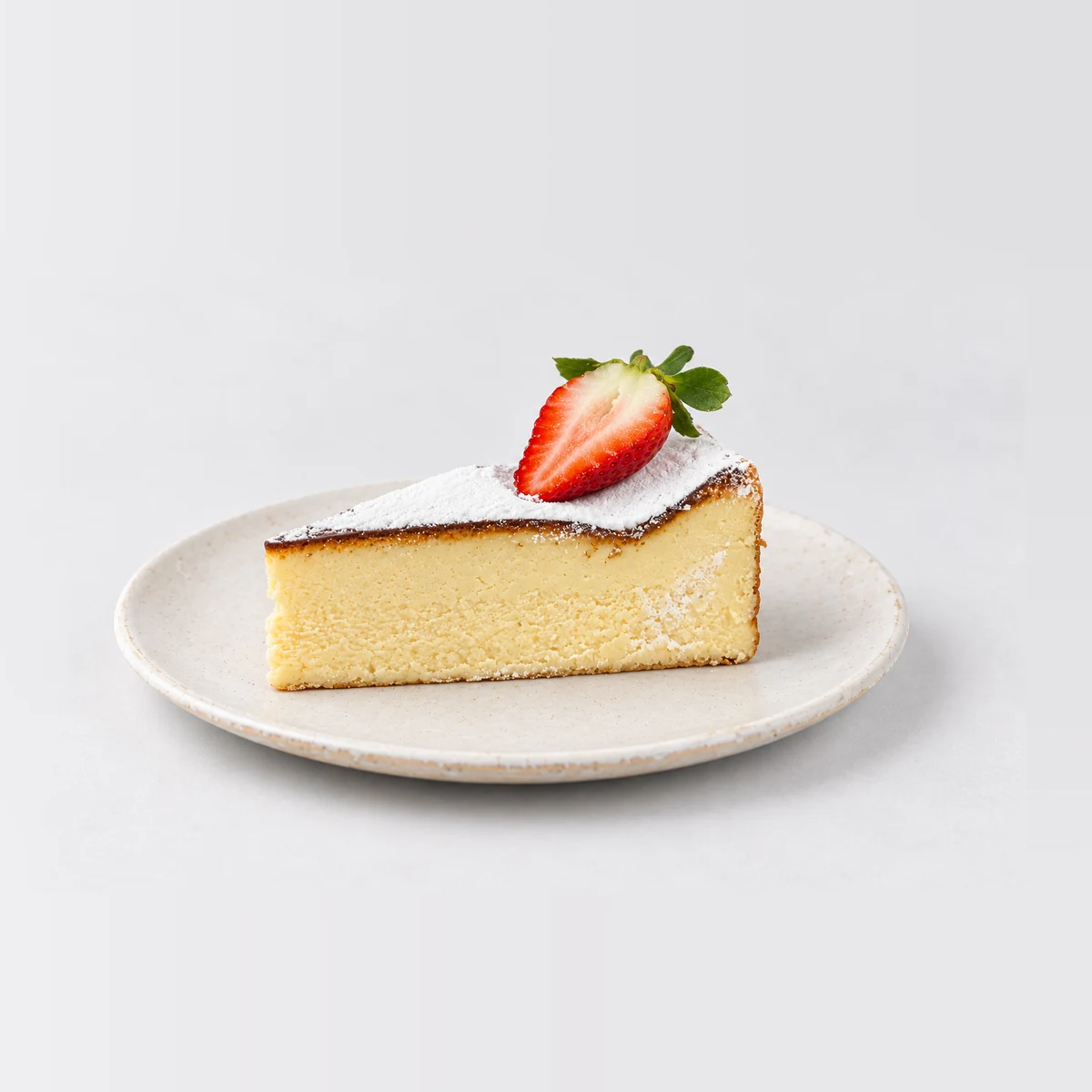 Side view of the Basque cheesecake slice showing the smooth pale cheesecake, with no base.