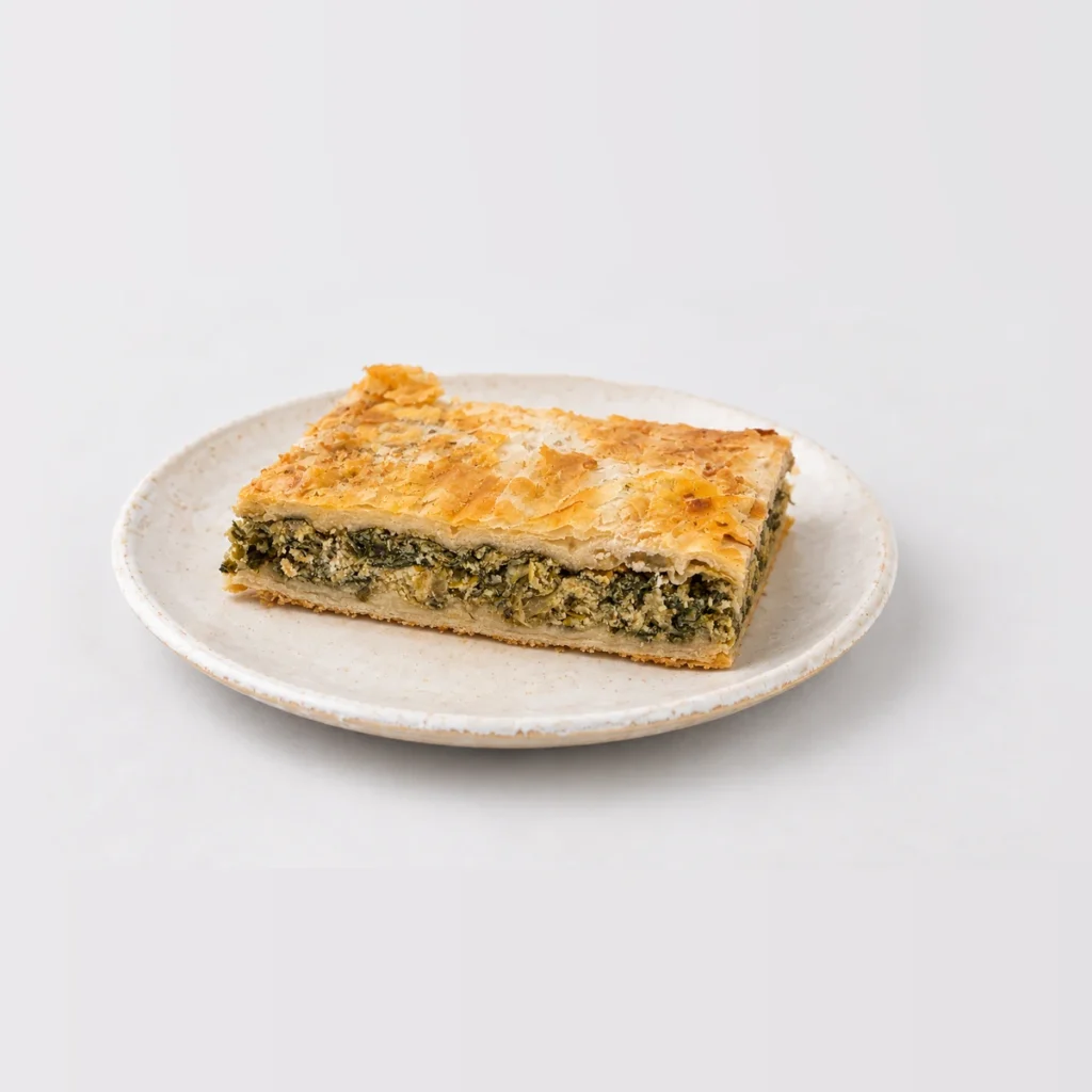 Spanakopita, whole on a plate