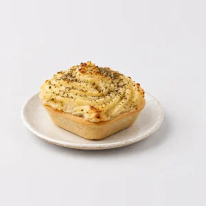 Steak and Potato Pie, whole on a plate