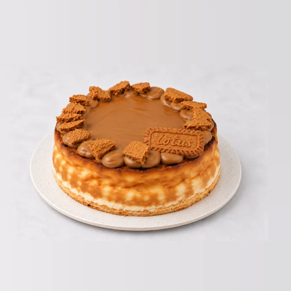 Side view of the baked Biscoff cheesecake showing the pale cream cheese filling under the Biscoff caramel topping.