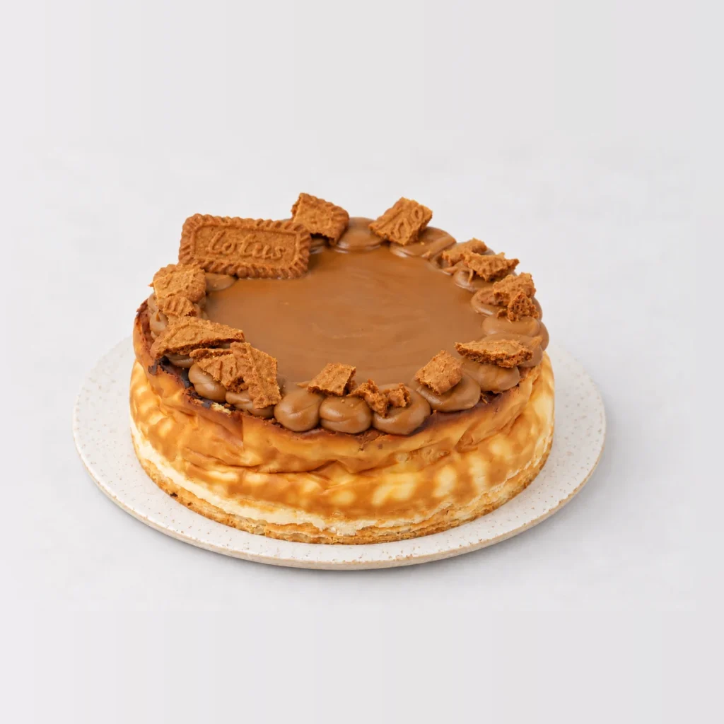 Baked Biscoff cheesecake topped with Biscoff caramel, piped rosettes and Lotus biscuits.