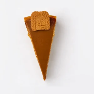 Biscoff cheesecake slice from above, showing the smooth caramel topping and Lotus biscuit.