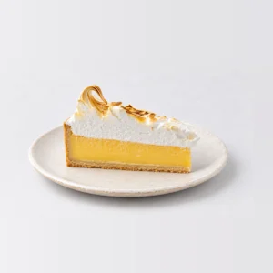 Side view of the lemon meringue slice with lemon curd, shortcrust and caramelised meringue peaks.