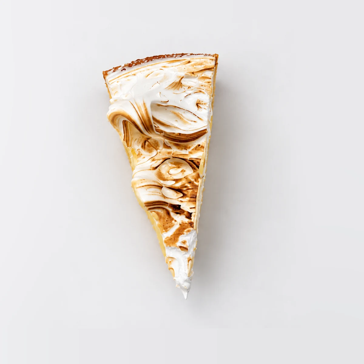 Lemon meringue tart slice from above, showing swirled caramelised meringue.