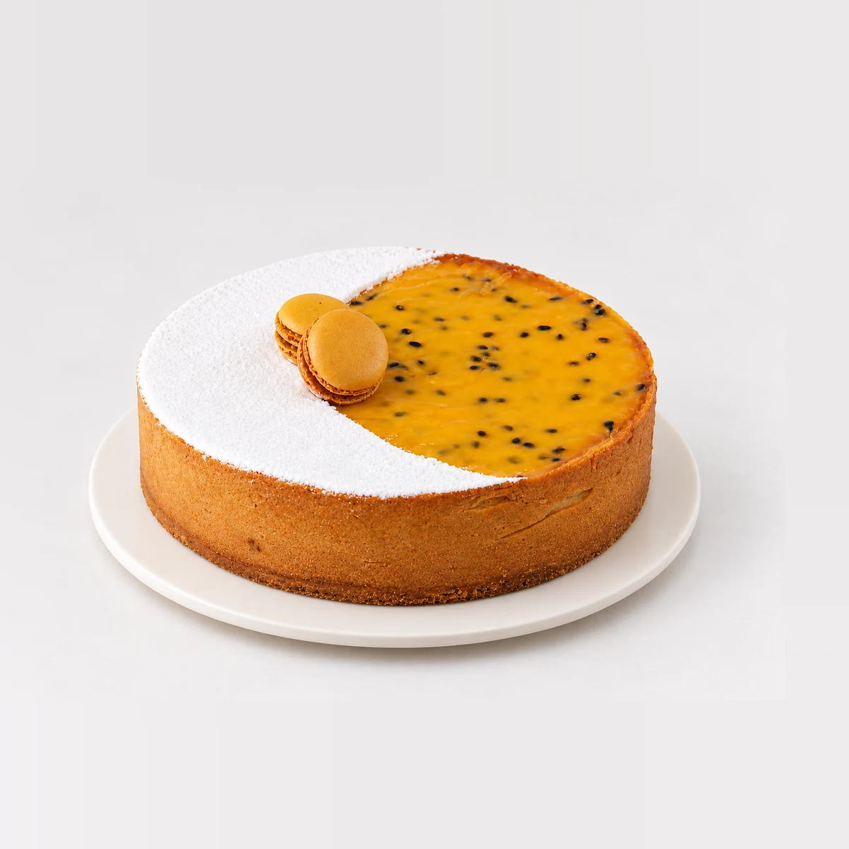 Side view of the passionfruit tart showing its shortcrust edge, passionfruit curd and macarons.