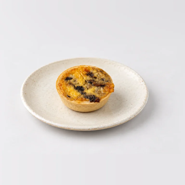 Party Egg, Mushroom & Cheese Quiche (Large - 40pc), whole on a plate