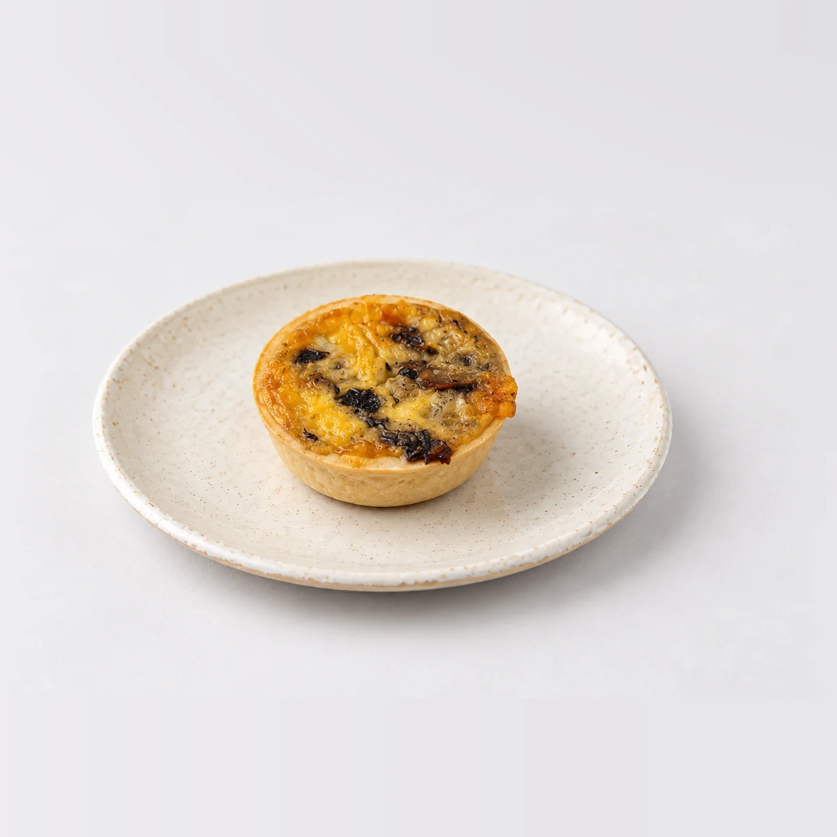 Party Egg, Mushroom & Cheese Quiche (Large - 40pc), whole on a plate