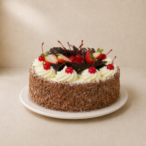 Black Forest sponge cake with chocolate shavings, cream rosettes, fresh strawberries and glace cherries.