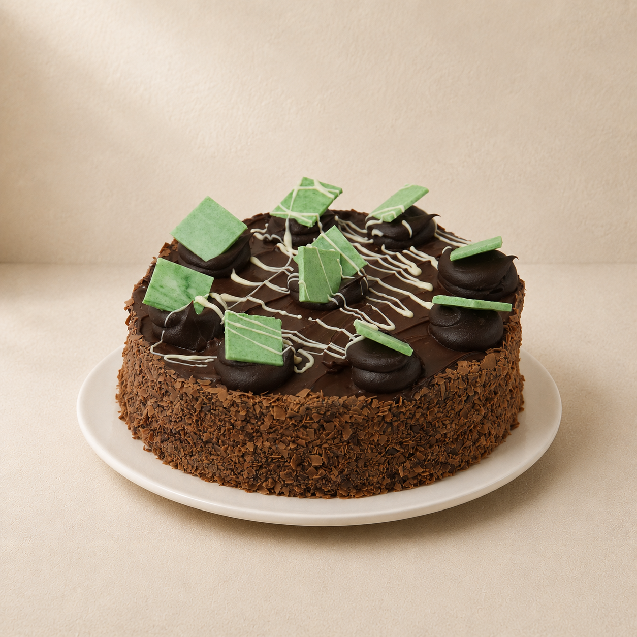 Chocolate Mint Slice Cake with a chocolate-crumb coating, topped with green mint chocolate pieces.