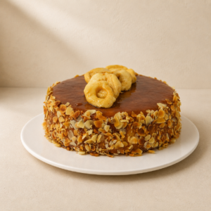 Flourless apple cake glazed with caramel, coated in flaked almonds and topped with apple.