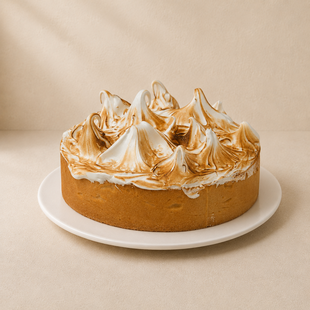 Lemon meringue tart topped with tall peaks of golden torched meringue.