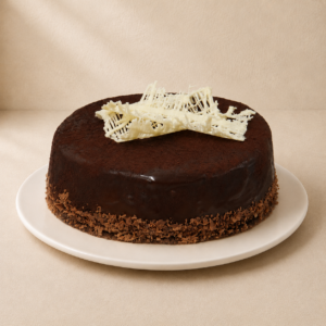 Mississippi Mud Cake with a glossy dark chocolate ganache and a white chocolate lattice on top.