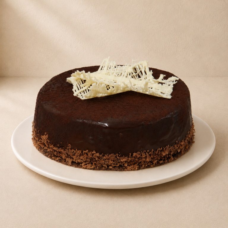 Mississippi Mud Cake with a glossy dark chocolate ganache and a white chocolate lattice on top.