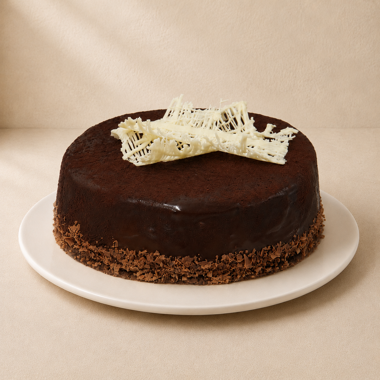 Mississippi Mud Cake with a glossy dark chocolate ganache and a white chocolate lattice on top.