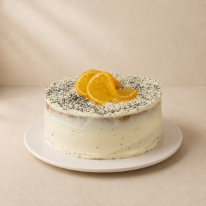 Orange and poppyseed tea cake with cream cheese frosting, poppyseeds and candied orange slices.
