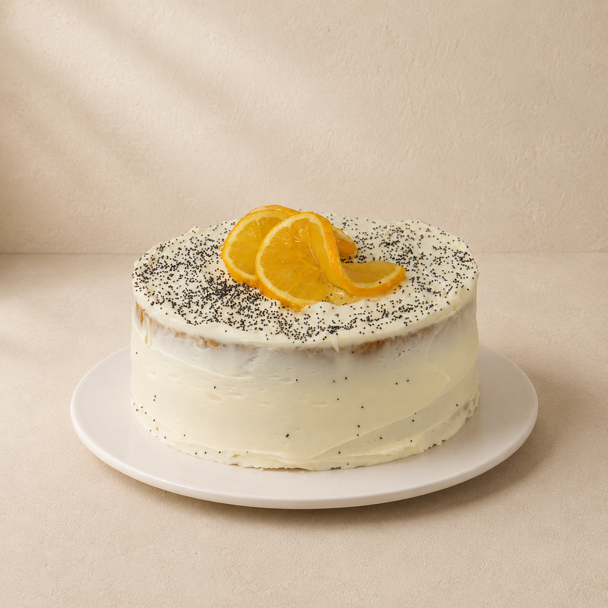 Orange and poppyseed tea cake with cream cheese frosting, poppyseeds and candied orange slices.