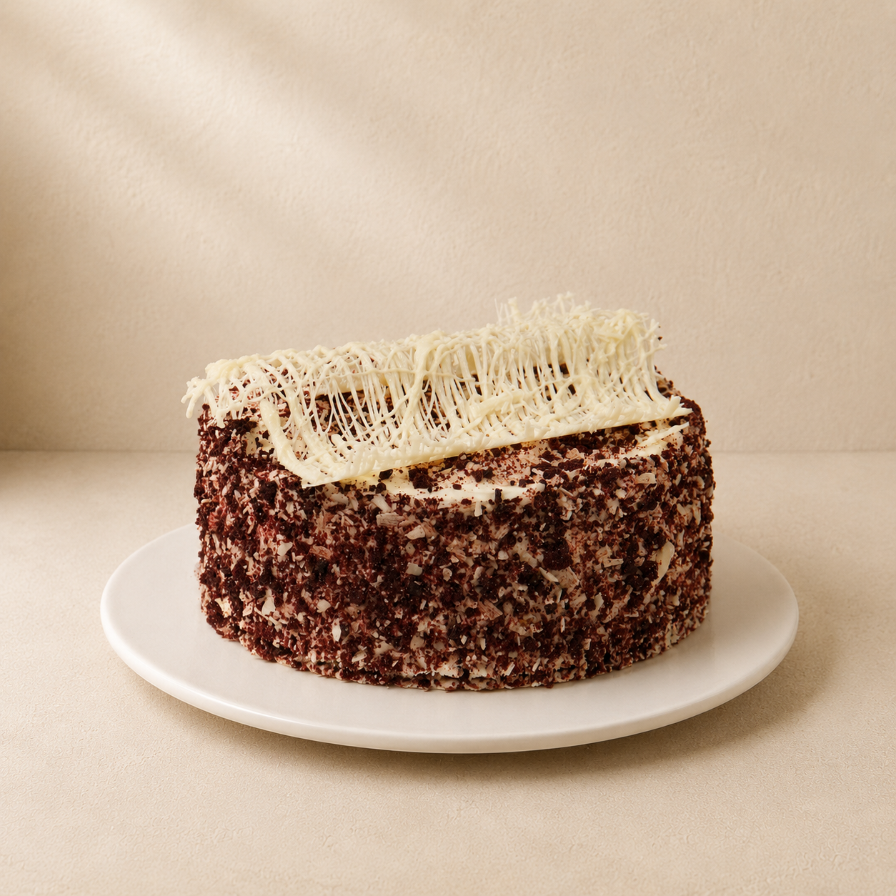 Red Velvet Cake with a red velvet crumb coating, cream cheese frosting and a white chocolate tuile.