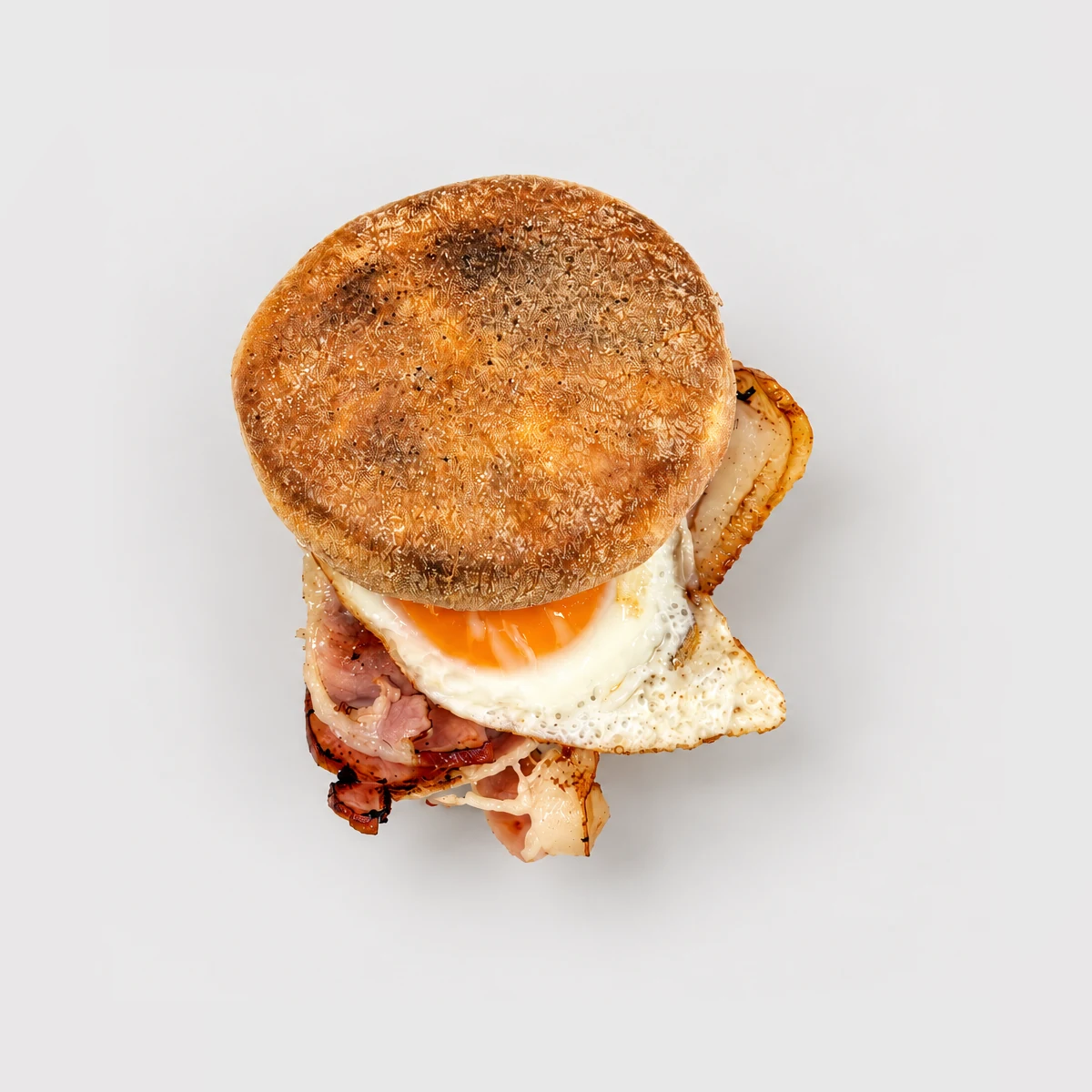 Egg and bacon breakfast roll / muffin — Top-down