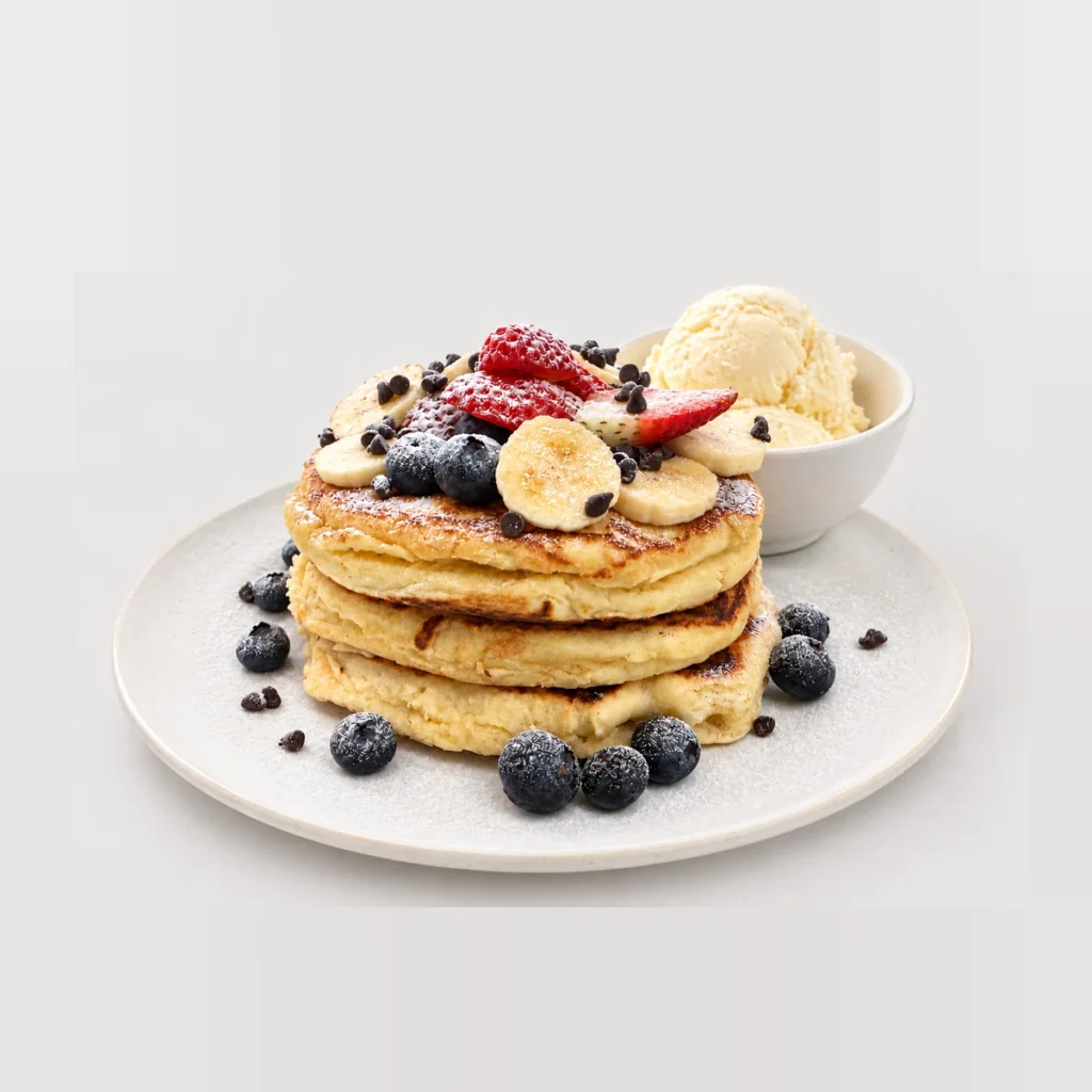 Tall pancake stack with fruit and ice cream — Detail