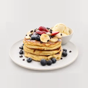 Tall pancake stack with fruit and ice cream — Detail