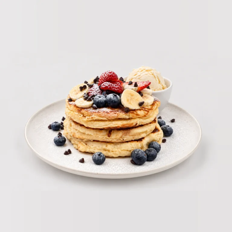 Tall pancake stack with fruit and ice cream — Whole / angled