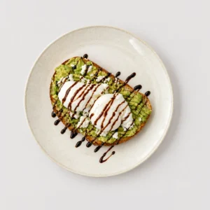 Avocado feta toast, poached eggs, dark drizzle — Top-down