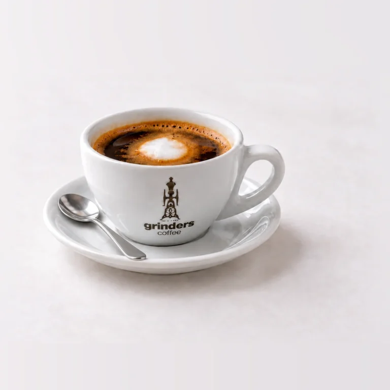 Long Macchiato in the smaller Grinders cup on white background